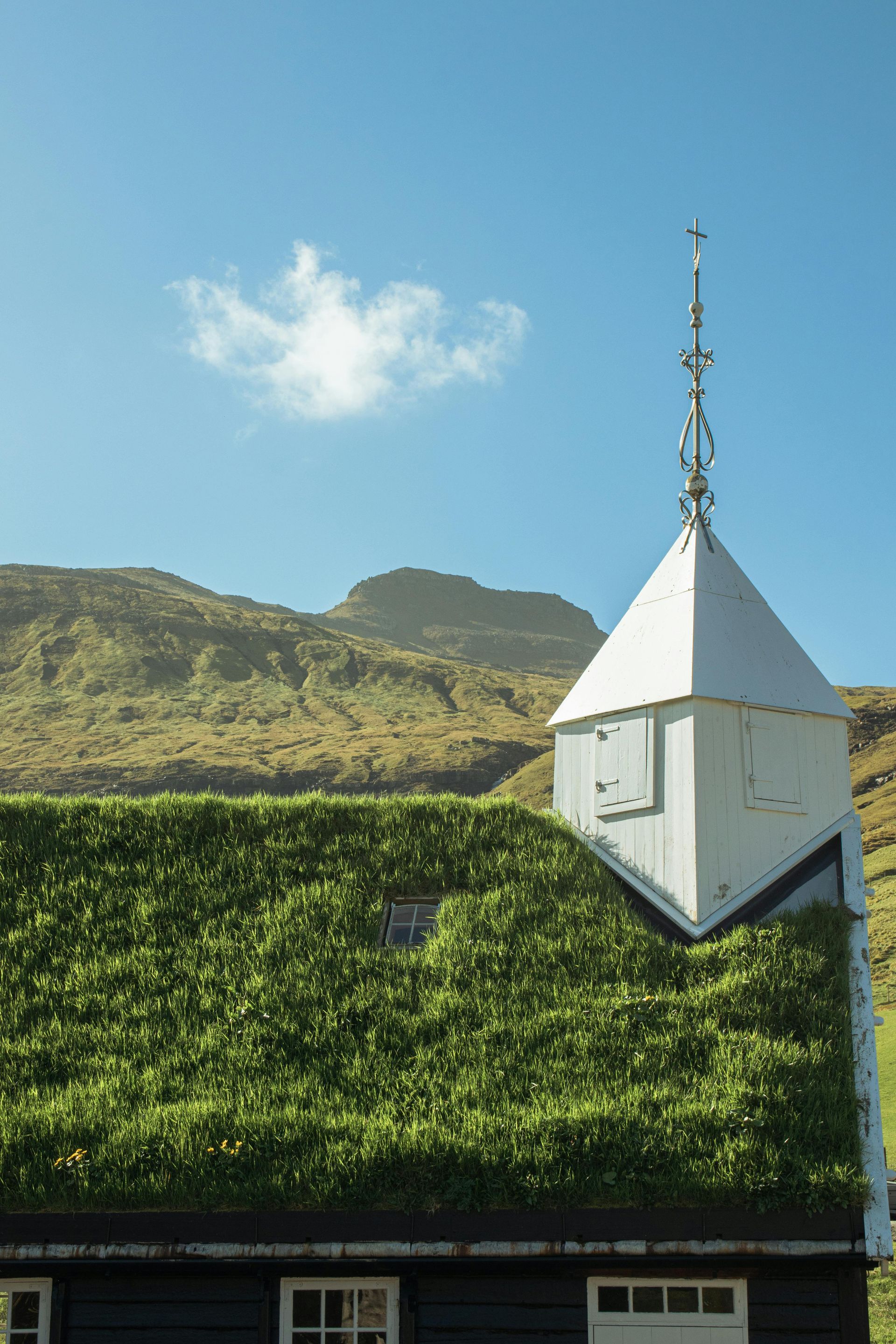 A man in a blue shirt and tie is using a laptop computer.