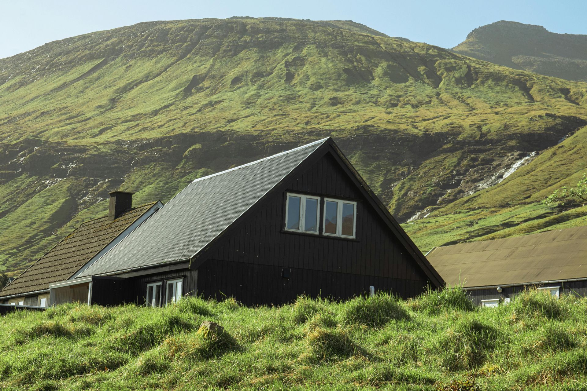 A man in a blue shirt and tie is using a laptop computer.