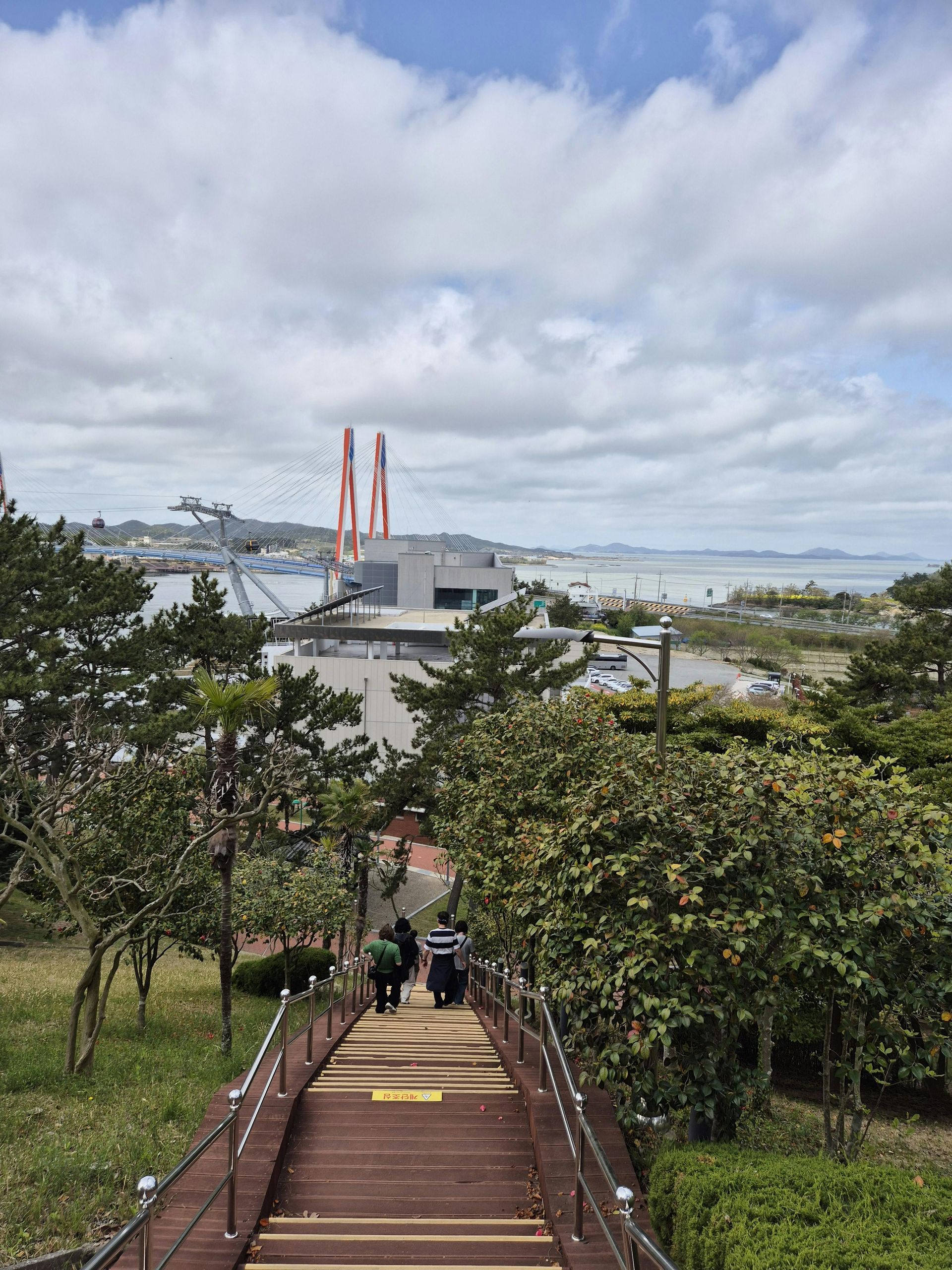 A man in a blue shirt and tie is using a laptop computer.