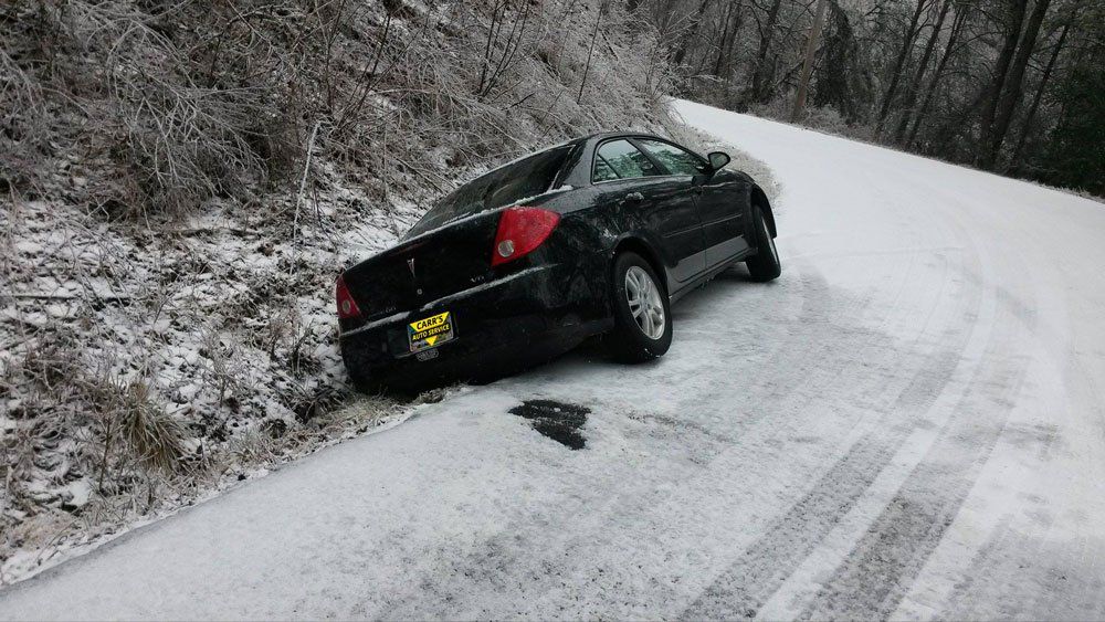 Black car slide on snow — Pigeon Forge, TN — Carr's Auto Service