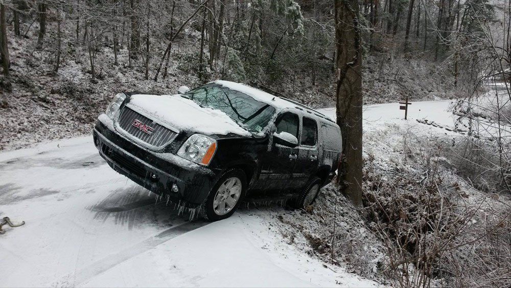 Black car cover with snow — Pigeon Forge, TN — Carr's Auto Service