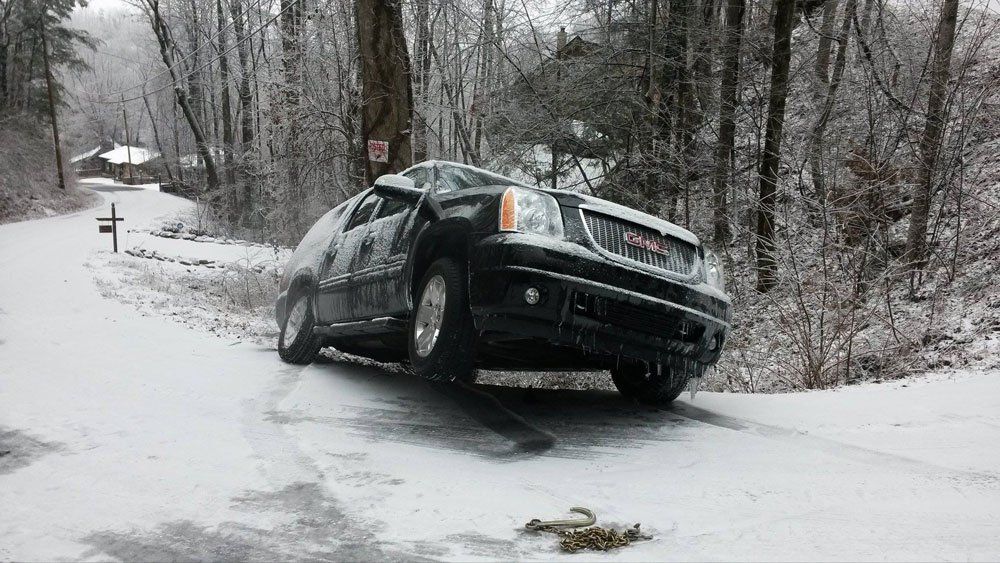 Black car cover with snow on the side of the road — Pigeon Forge, TN — Carr's Auto Service