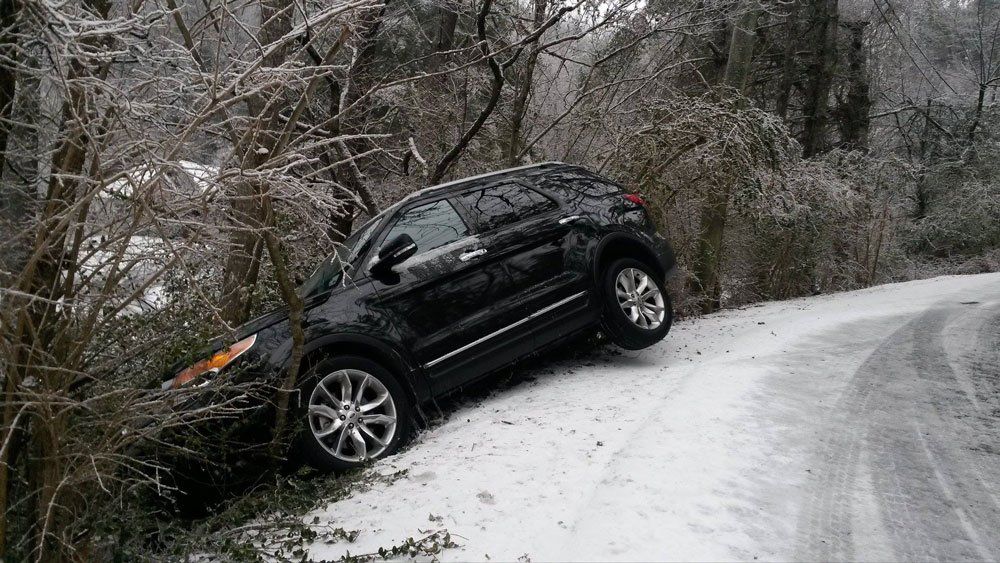 Black car stuck in the side of the road — Pigeon Forge, TN — Carr's Auto Service
