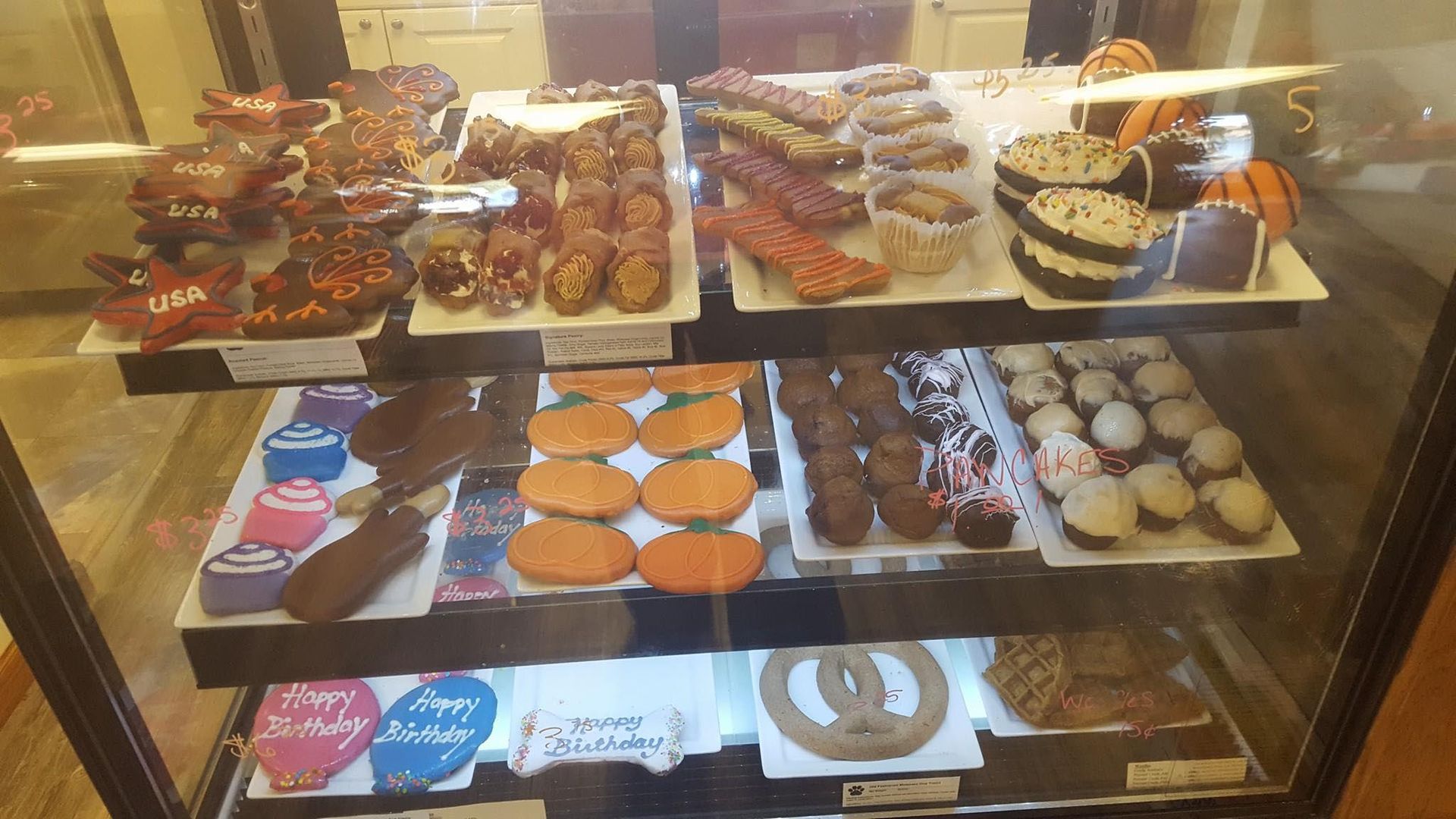 A display case filled with lots of different types of cookies.