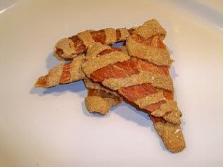 A close up of a piece of pizza on a white plate.