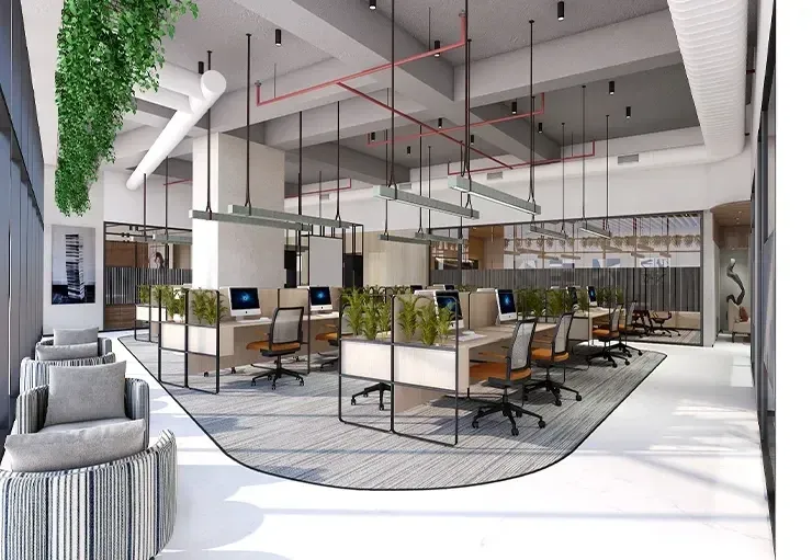 Modern office space with workstations, green plants, desk chairs, and large windows on a patterned carpeted area.