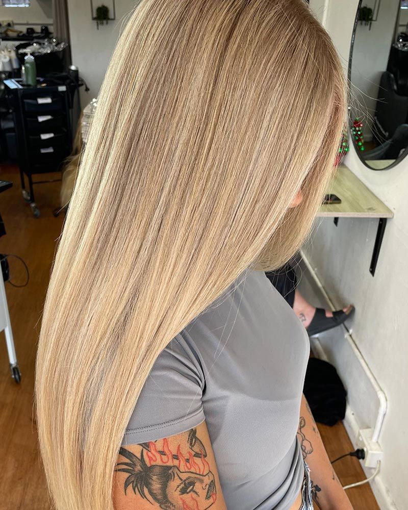 A Woman With Long Blonde Hair is Standing in a Room — Hairenvy in Ettalong Beach, NSW