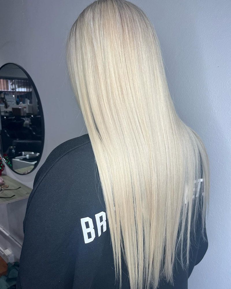 A Woman With Straight Blonde Hair inside the Salon — Hairenvy in Ettalong Beach, NSW