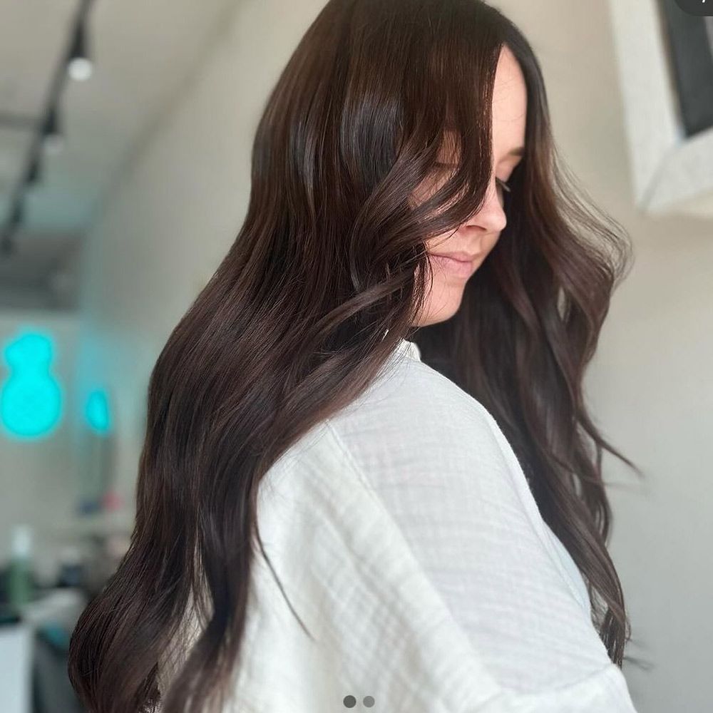 A Woman With Long Brown Hair is Wearing a White Shirt — Hairenvy in Ettalong Beach, NSW