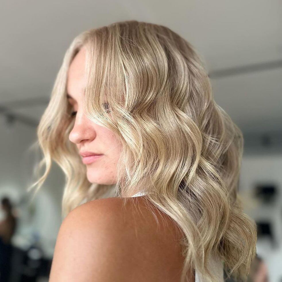 A Woman With Blonde Hair is Looking Over Her Shoulder — Hairenvy in Ettalong Beach, NSW