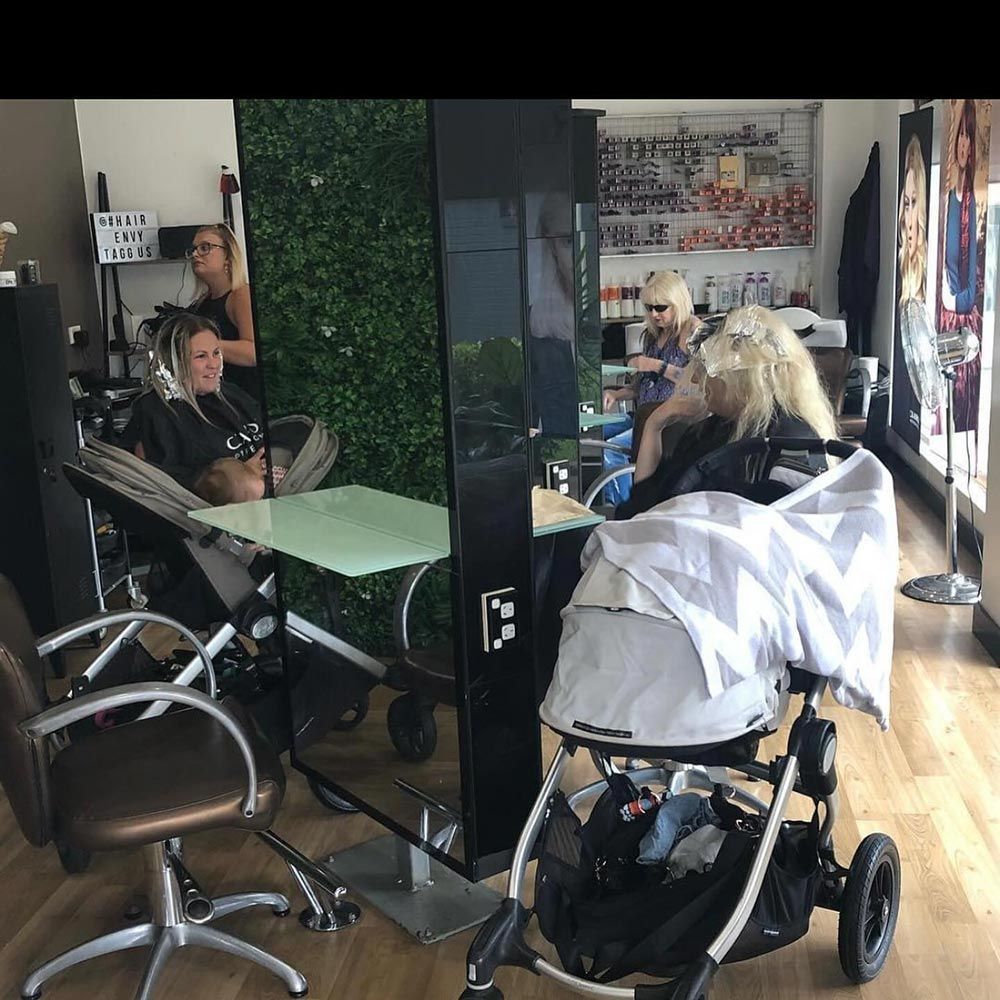 A Stroller is Parked in Front of a Mirror in a Salon — Hairenvy in Ettalong Beach, NSW