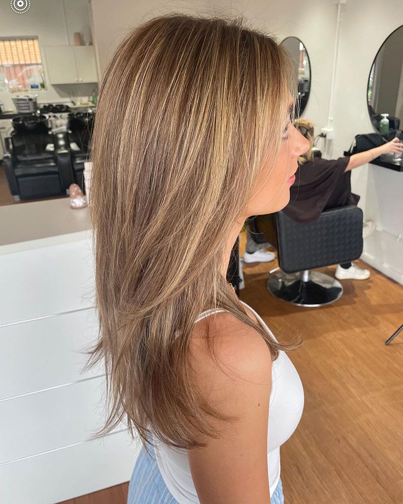 A Woman is Getting Her Hair Cut at a Salon — Hairenvy in Ettalong Beach, NSW