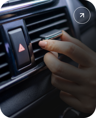 Hand adjusting a car air vent beside the hazard light button | Kelly Automotive
