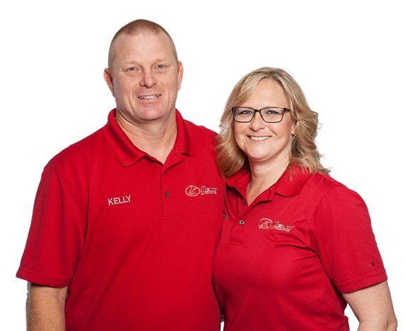 Two smiling people in red polo shirts posing against a white background | Kelly Automotive