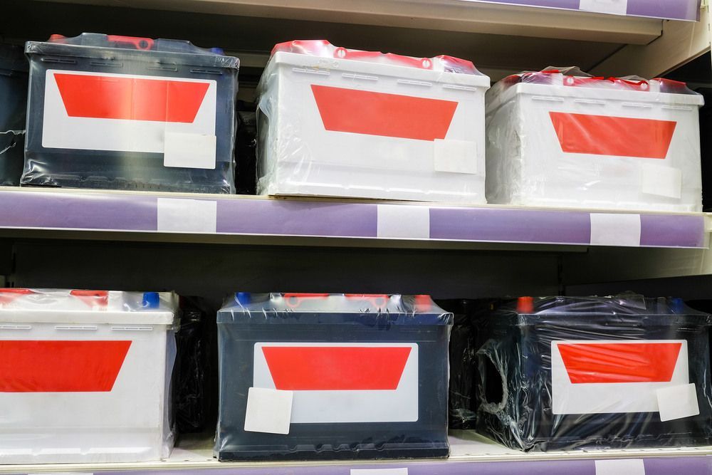 A Bunch Of Batteries Are Sitting On A Shelf In A Store — Bernie's Tyres In Kawana, QLD