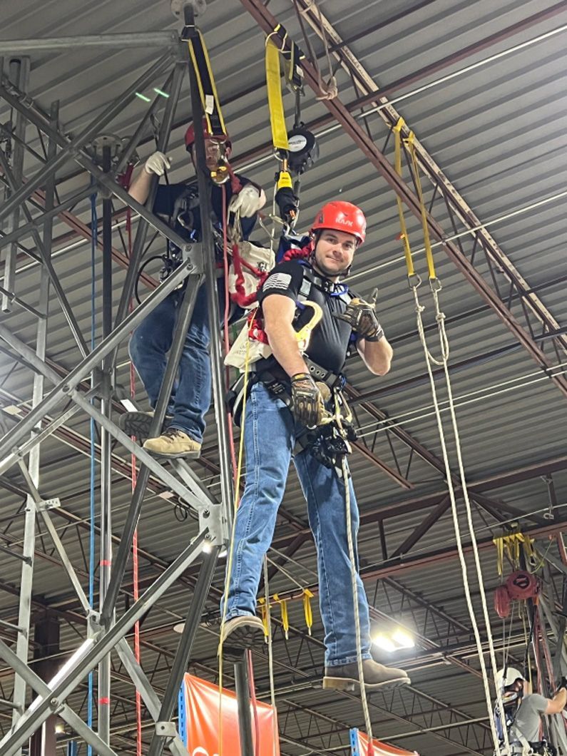 A man is standing on a ladder in a building.