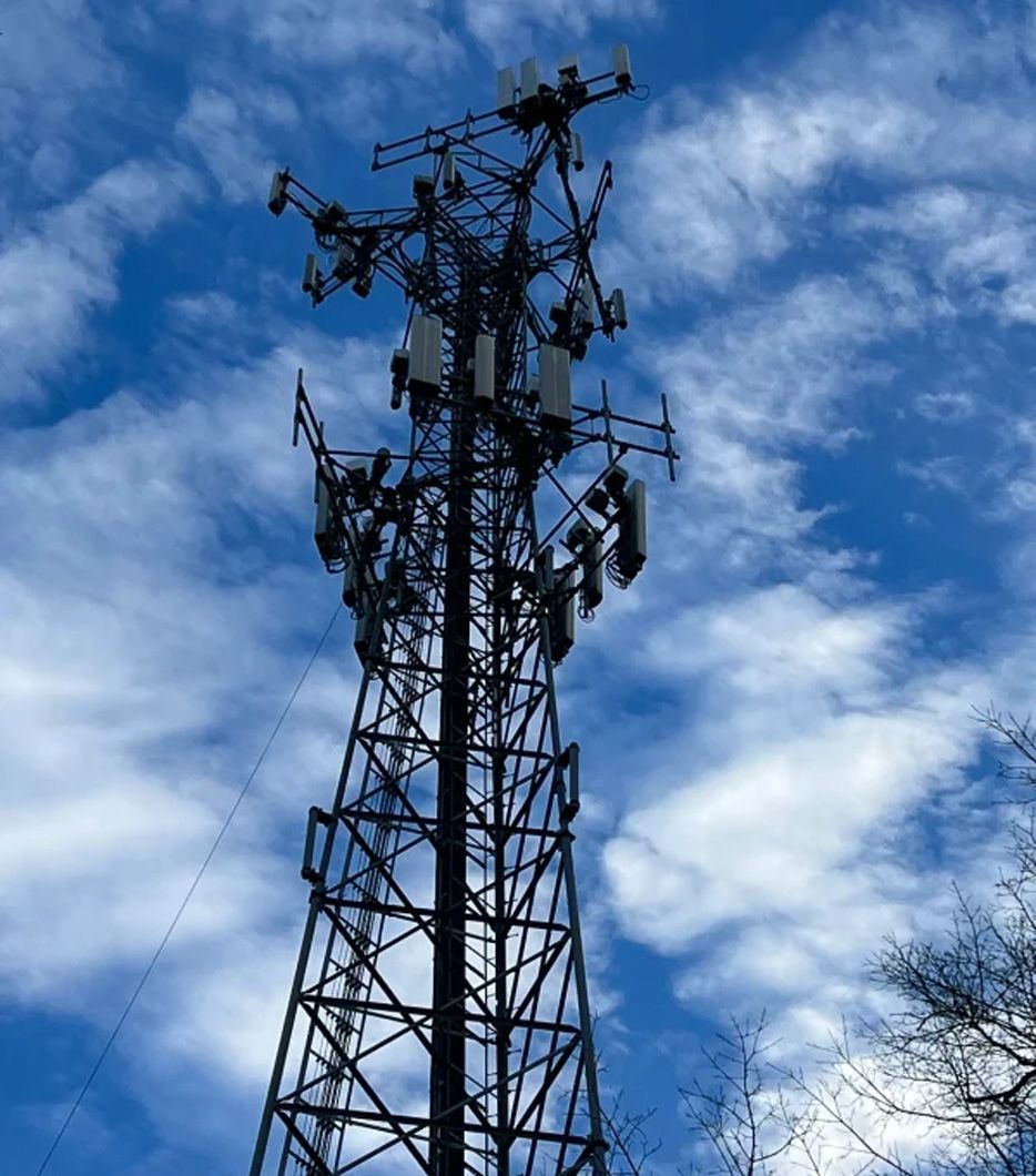 A telephone tower with a blue sky in the background
