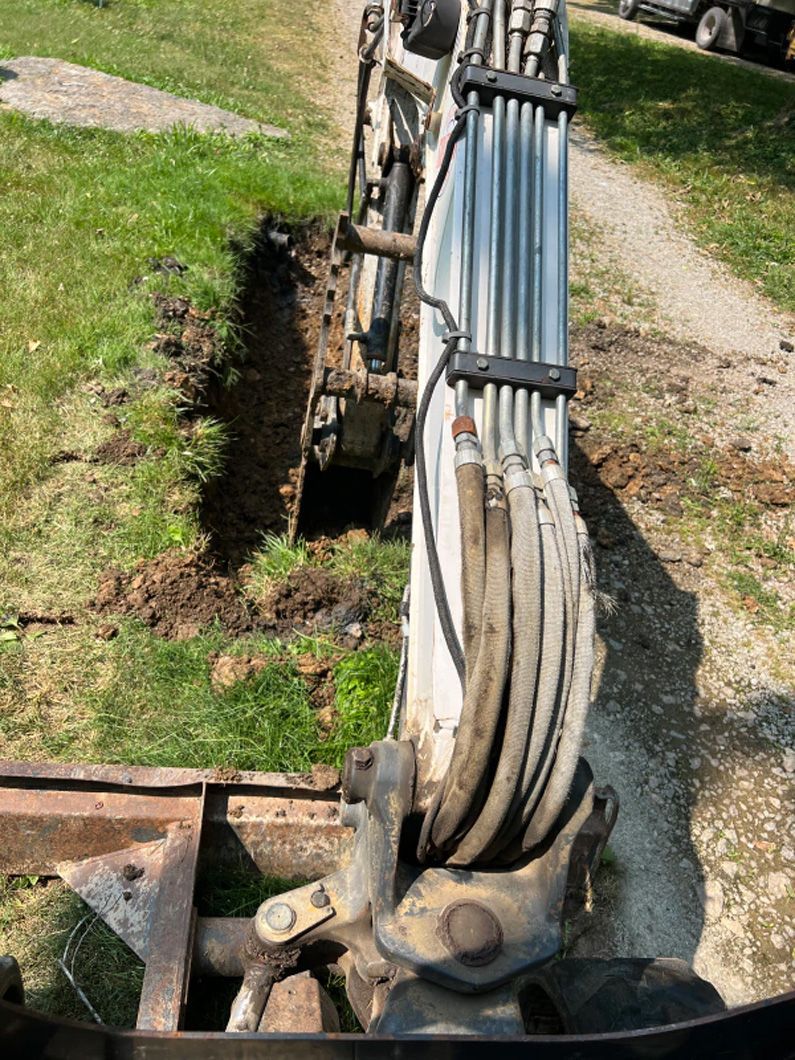 A large machine is digging a hole in the ground.