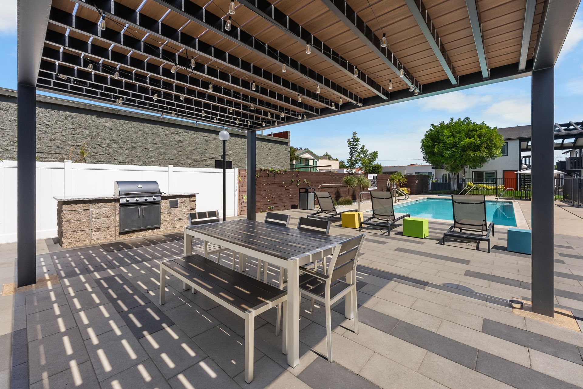 Sliding Photo Gallery Displaying Community Amenities - picnic table and BBQ grill poolside