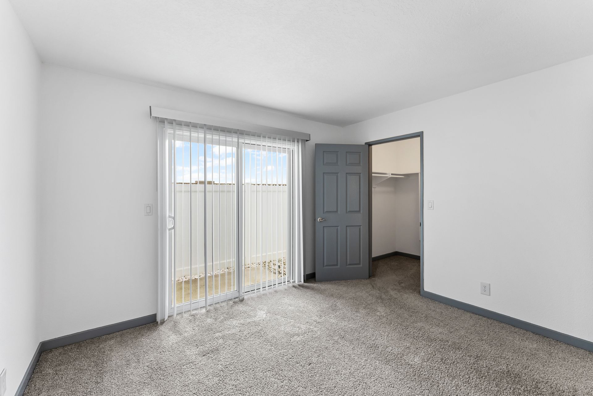 Sliding Photo Gallery Displaying Apartment Features- Bedroom with glass door to patio