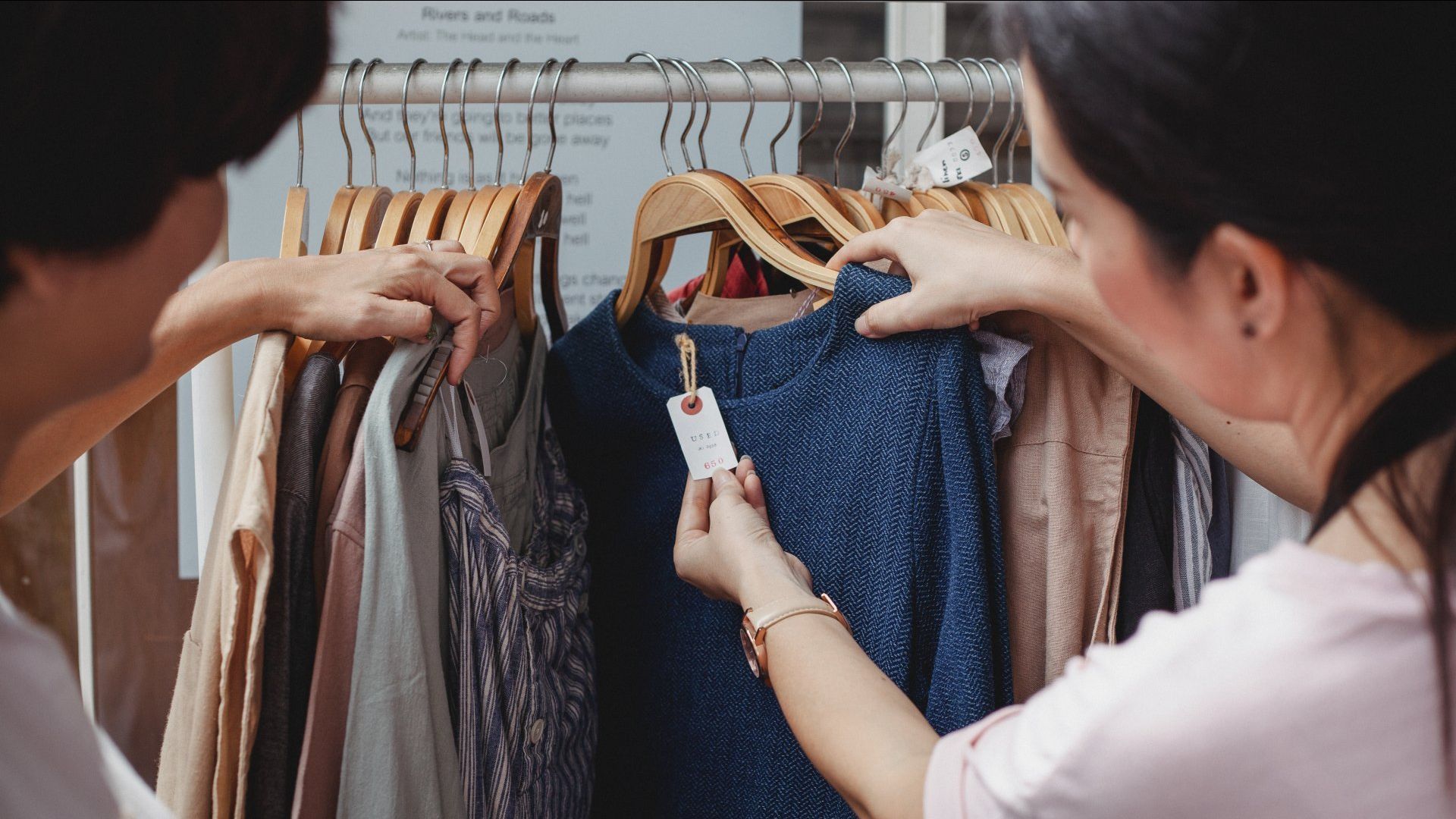 a woman checking the price tag of clothes