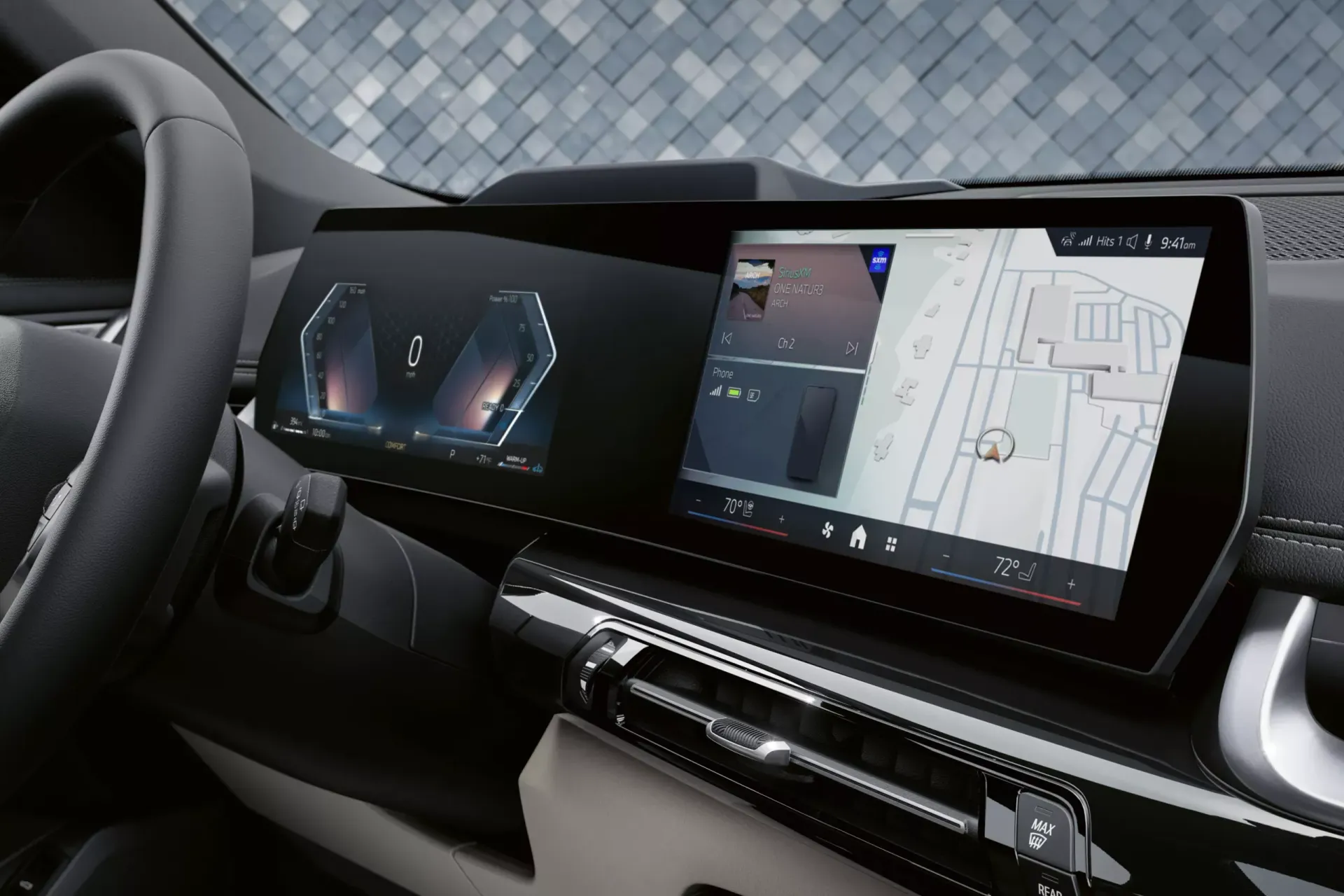 Dashboard with digital displays; navigation map shown on right screen. Steering wheel on left.