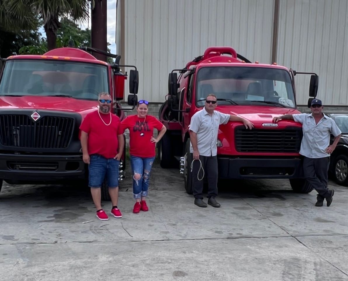 Two semi-trucks, one blue and one white, parked outdoors.
