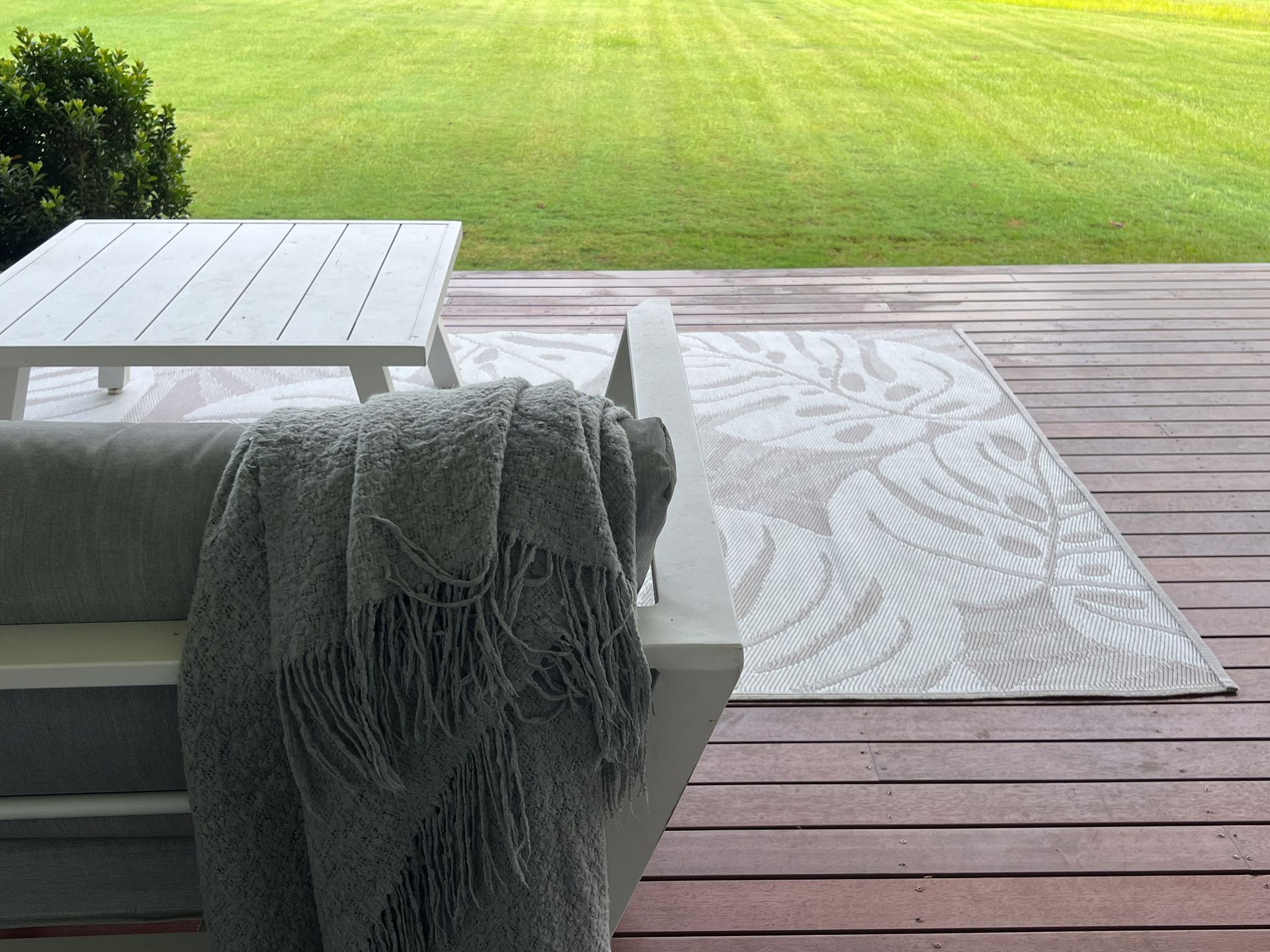 A shaggy light gray rug on a wooden floor.