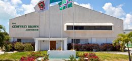A large white building with flags flying in front of it.