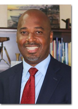 a man in a suit and tie is smiling for the camera .