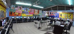 A large room filled with lots of computers and chairs.