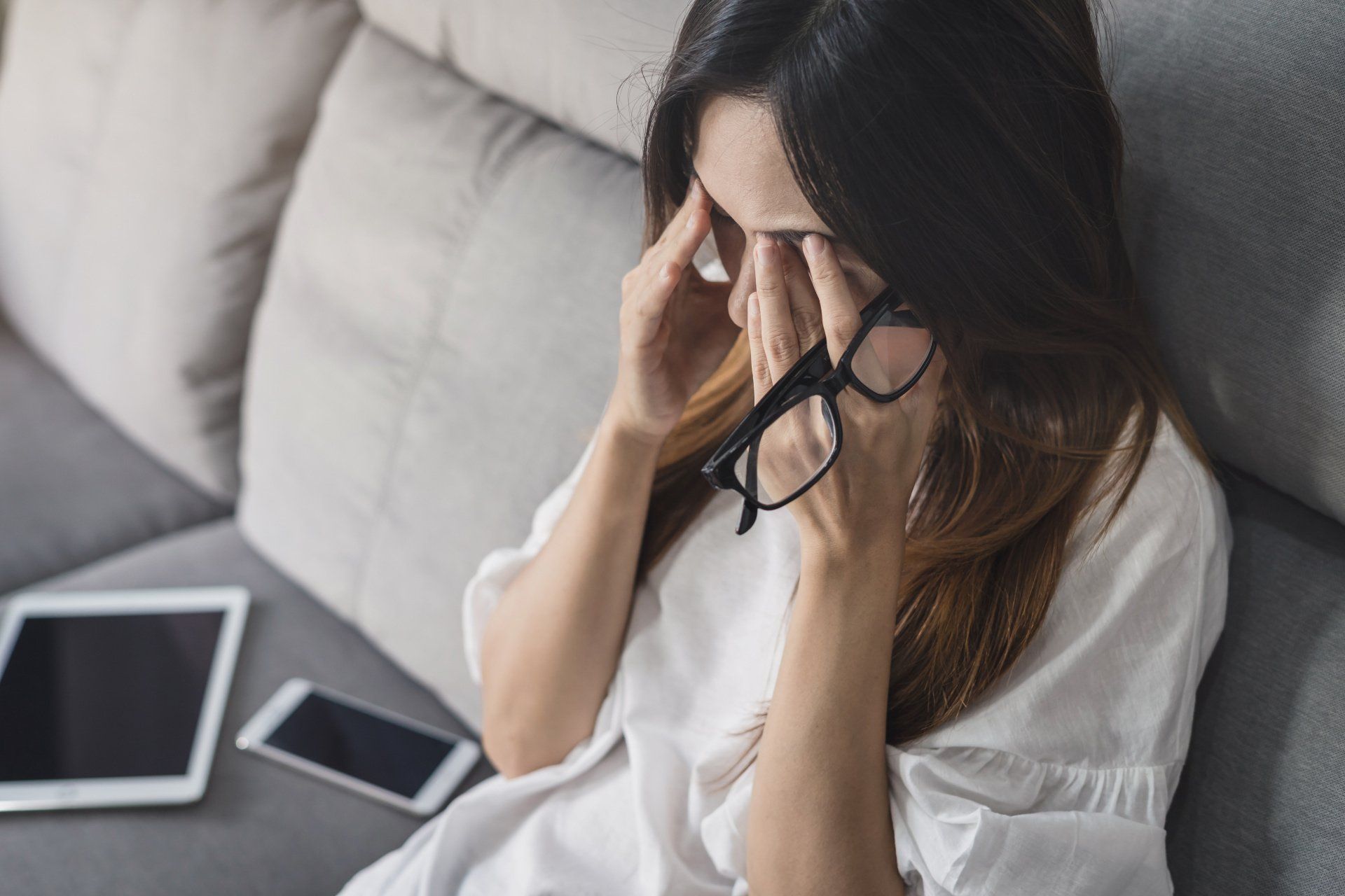 woman sitting on a couch stressed out