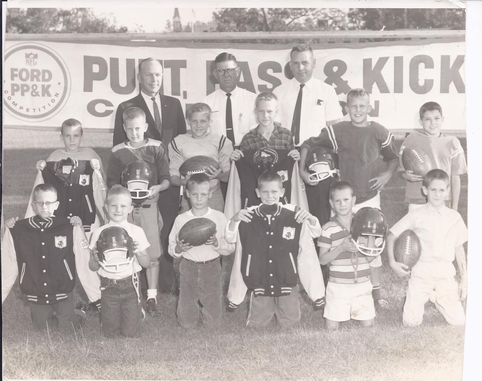 1960s Boys & Girls Club Punt, Pass, and Kick football competition with kids holding footballs