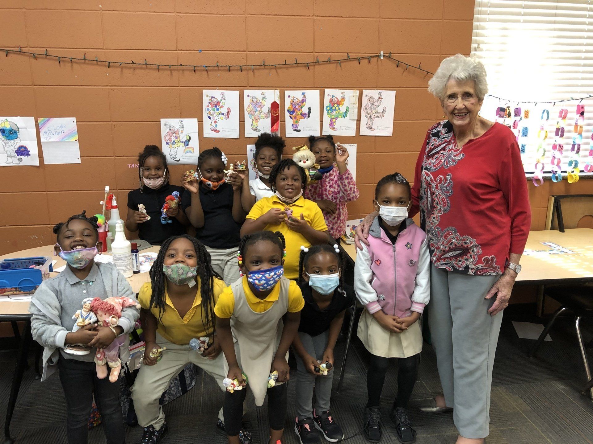 Teacher with group of students wearing masks in Boys & Girls Club classroom