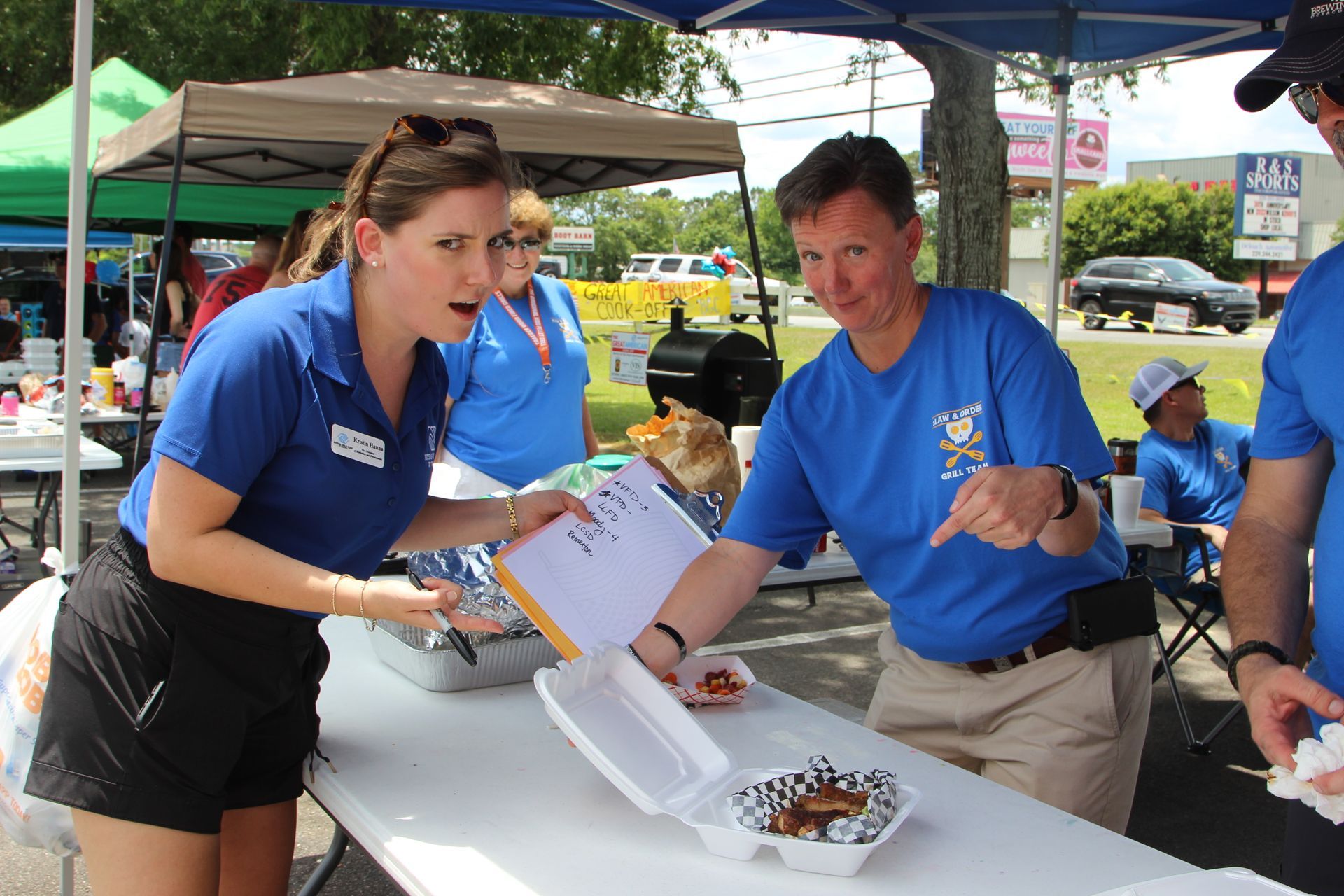 Boys & Girls Club of Valdosta CEO judging BBQ at BBQ cook-off. 