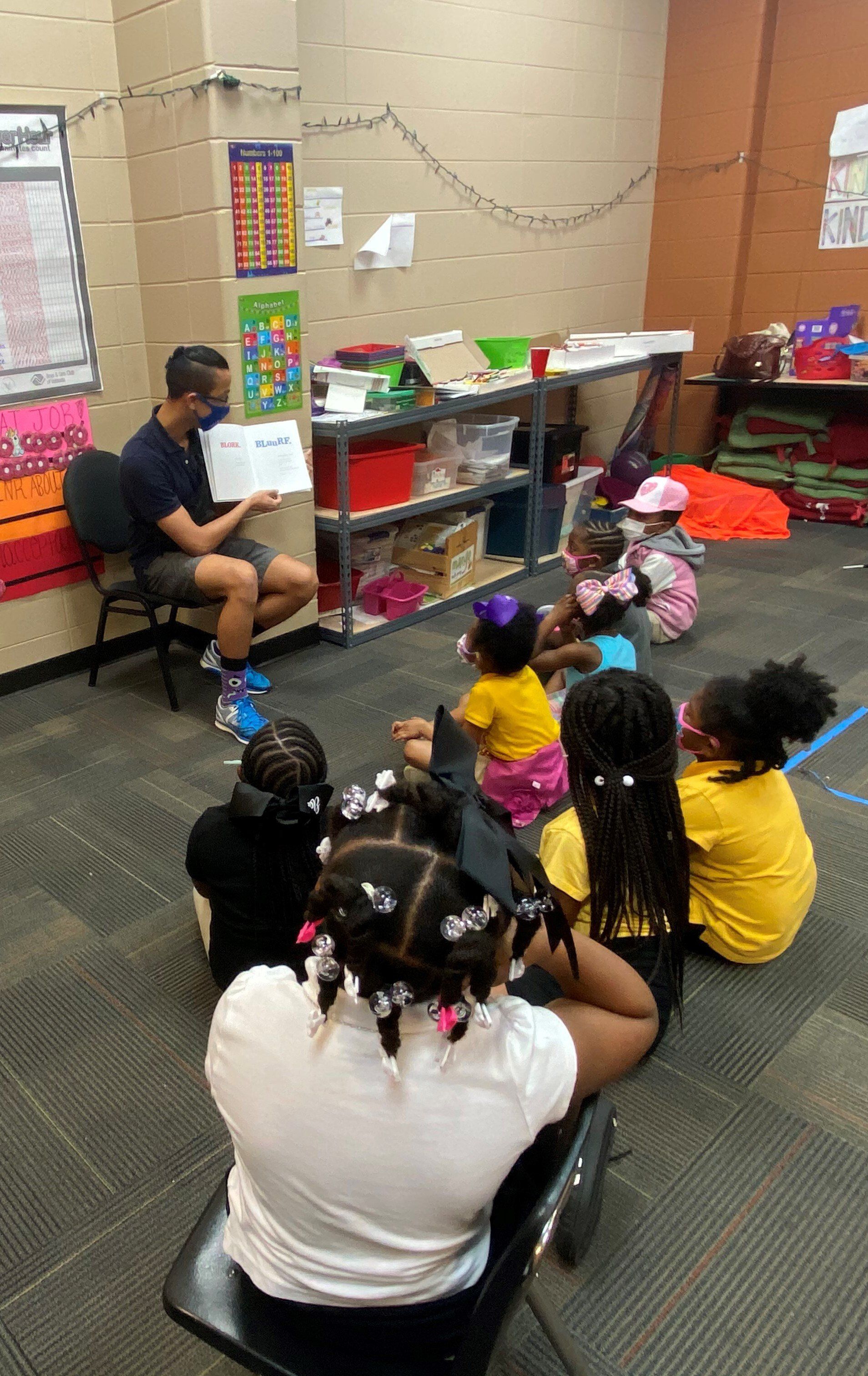 Teacher reading book aloud at Boys & Girls Club classroom