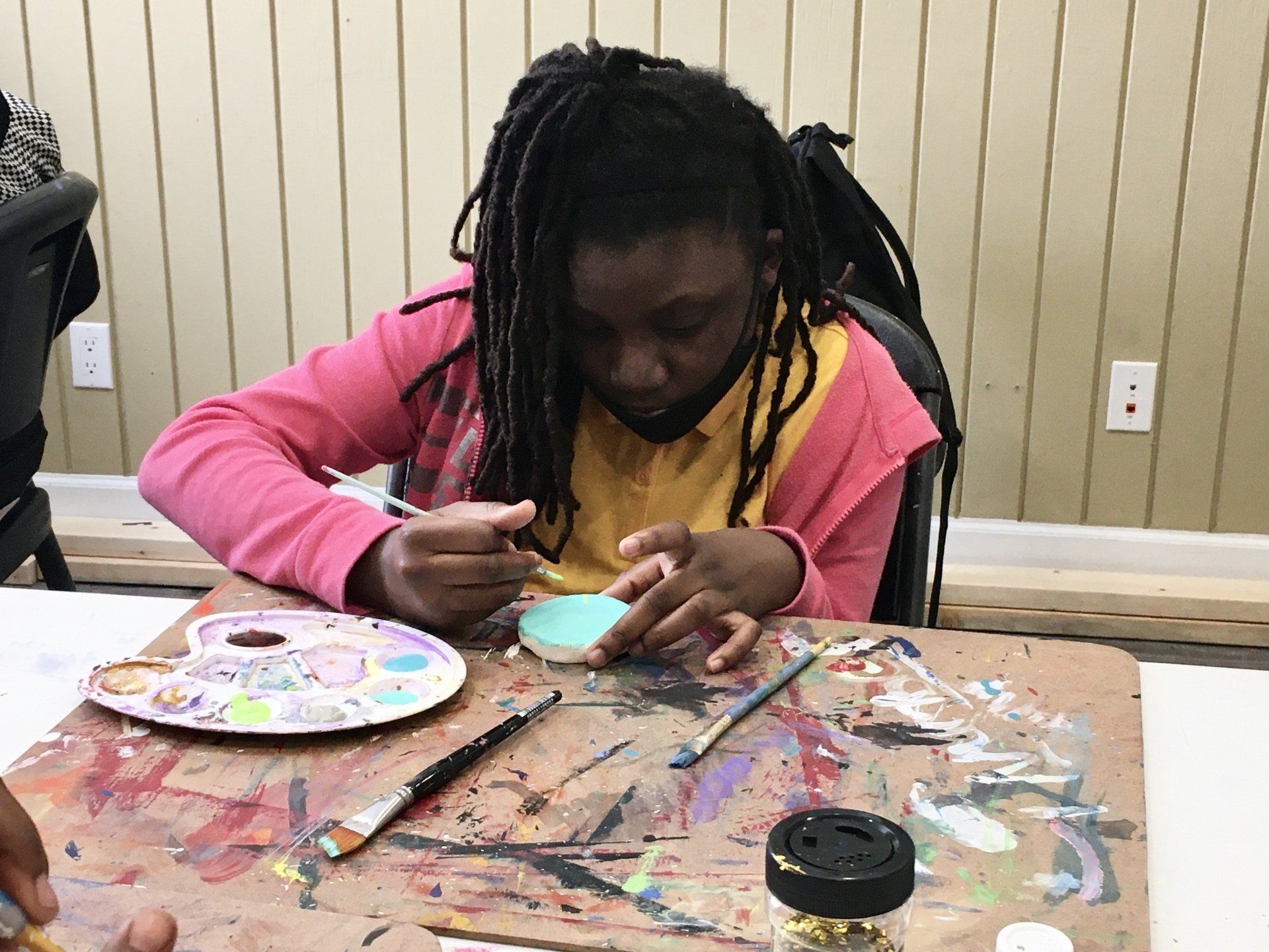 Child painting during Boys & Girls Club art activity
