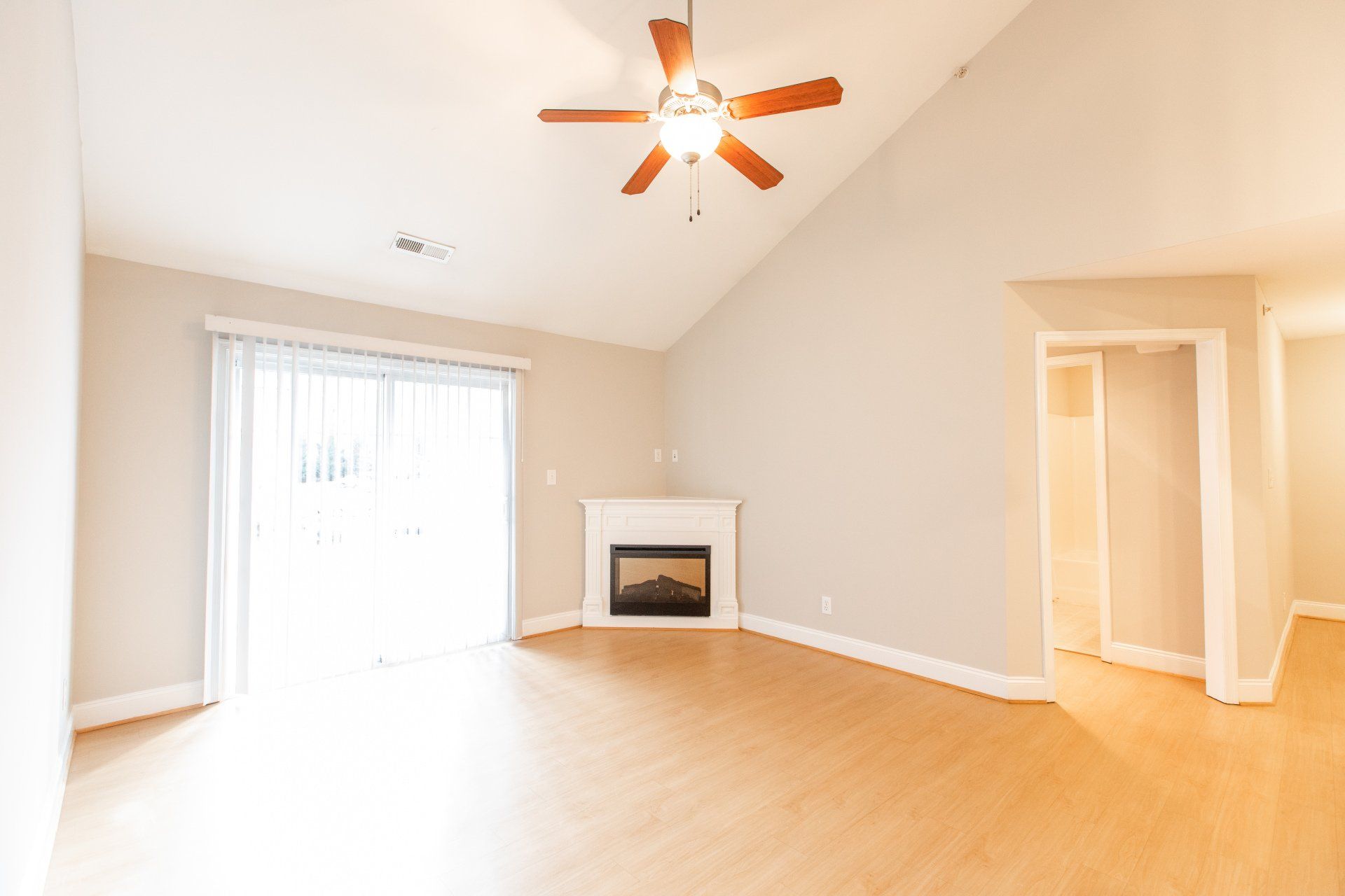 Living room with ceiling fan and fireplace