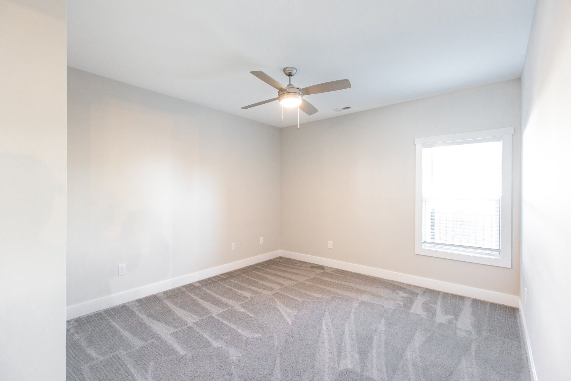 Bedroom with ceiling fan and carpet