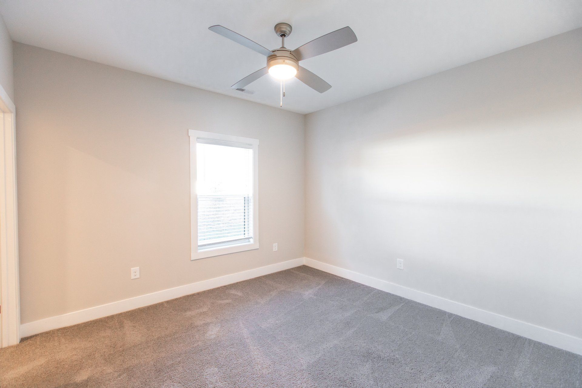 Bedroom with ceiling fan and carpet