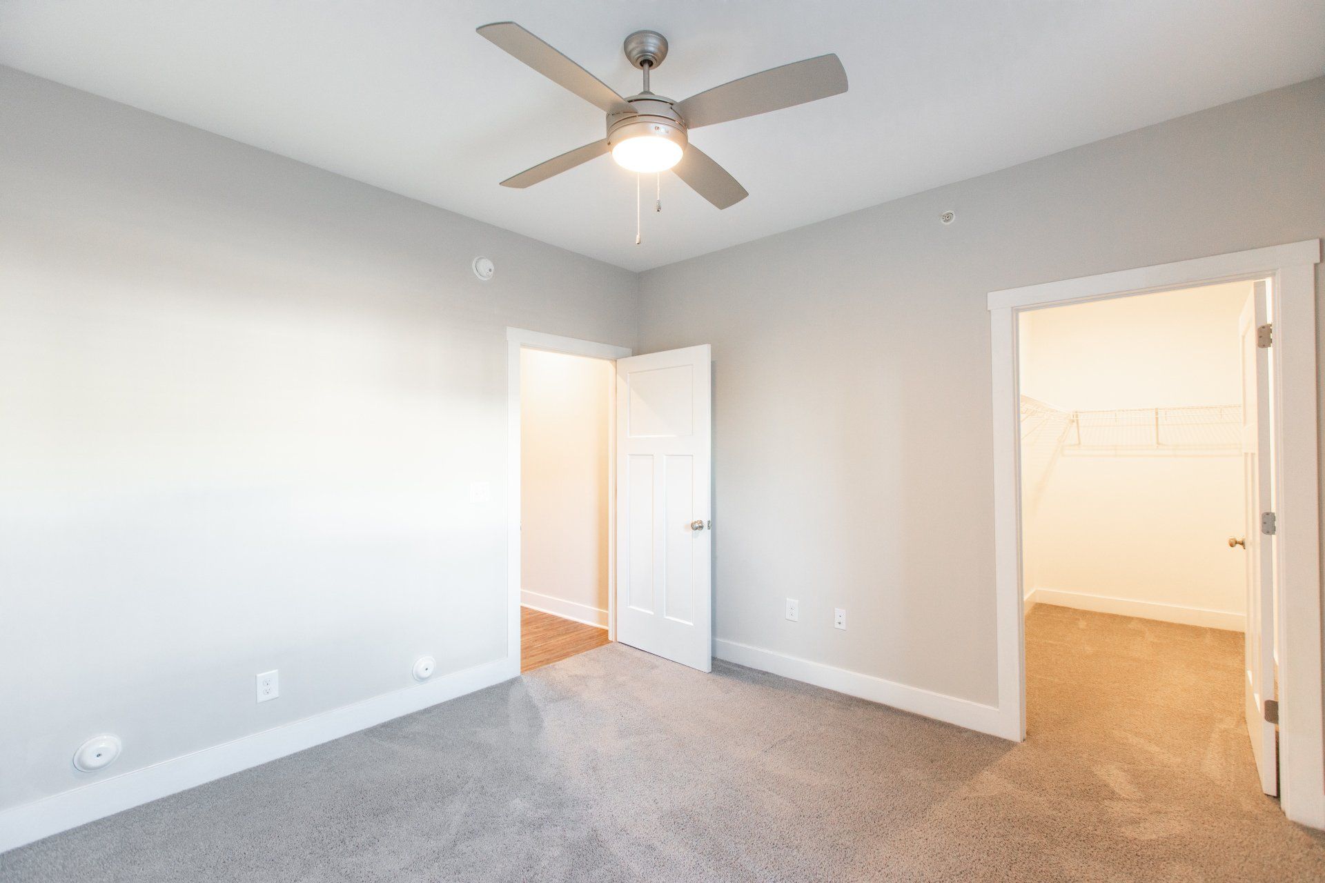 Bedroom with ceiling fan and carpet