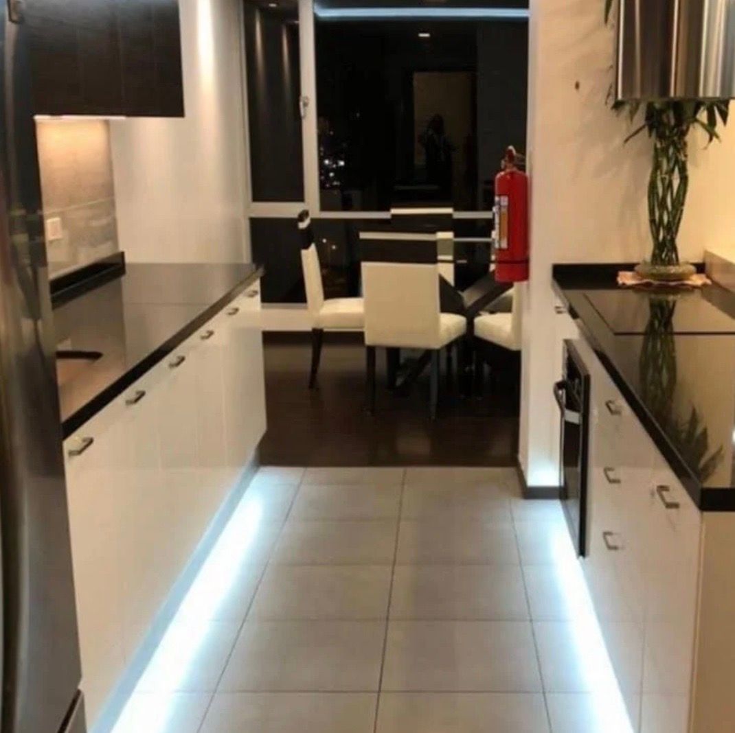 A kitchen with a fire extinguisher on the counter