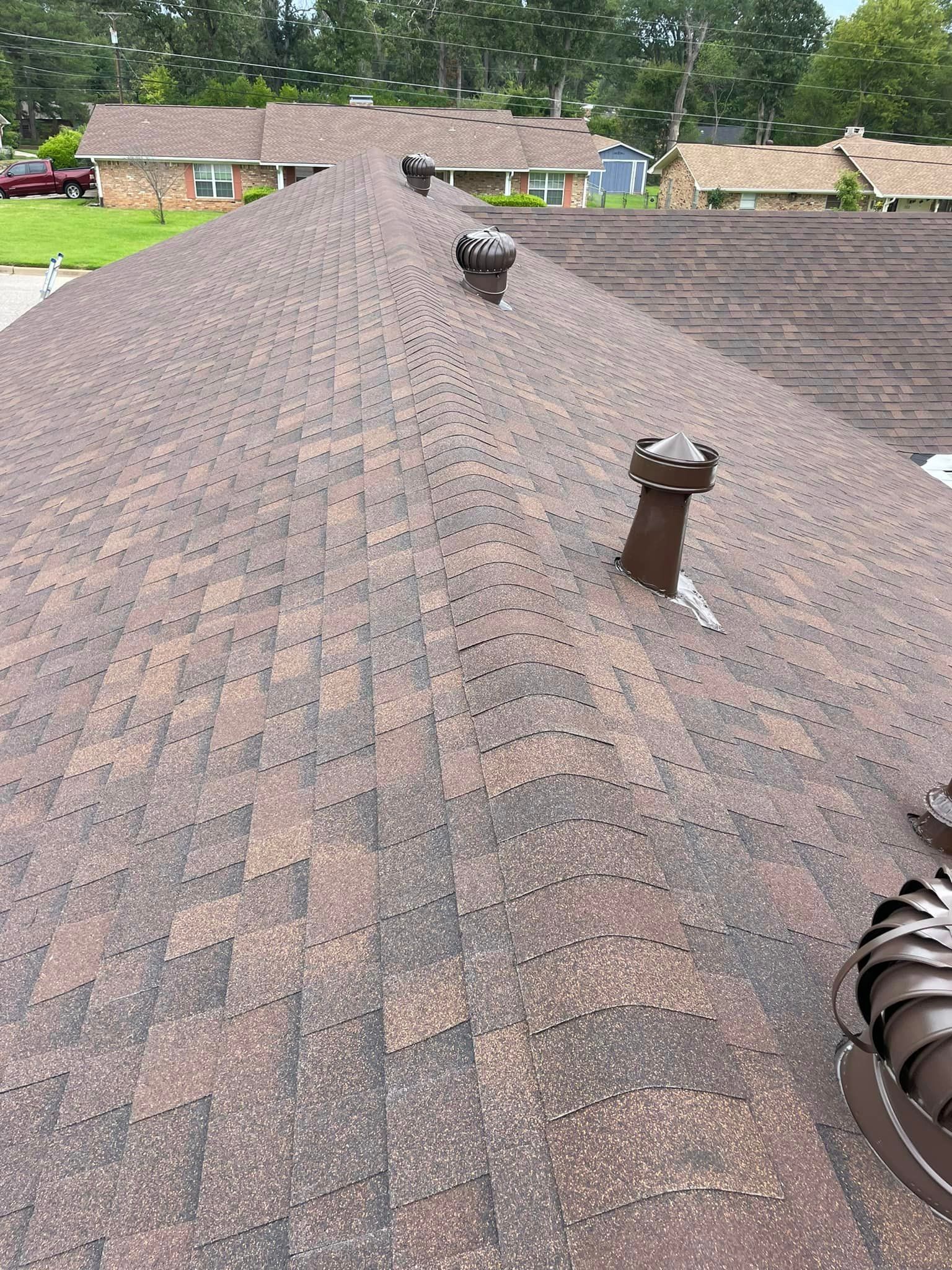 A close up of a roof with a chimney on it.