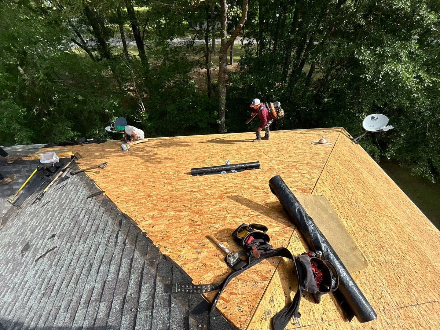 A man is working on the roof of a house.