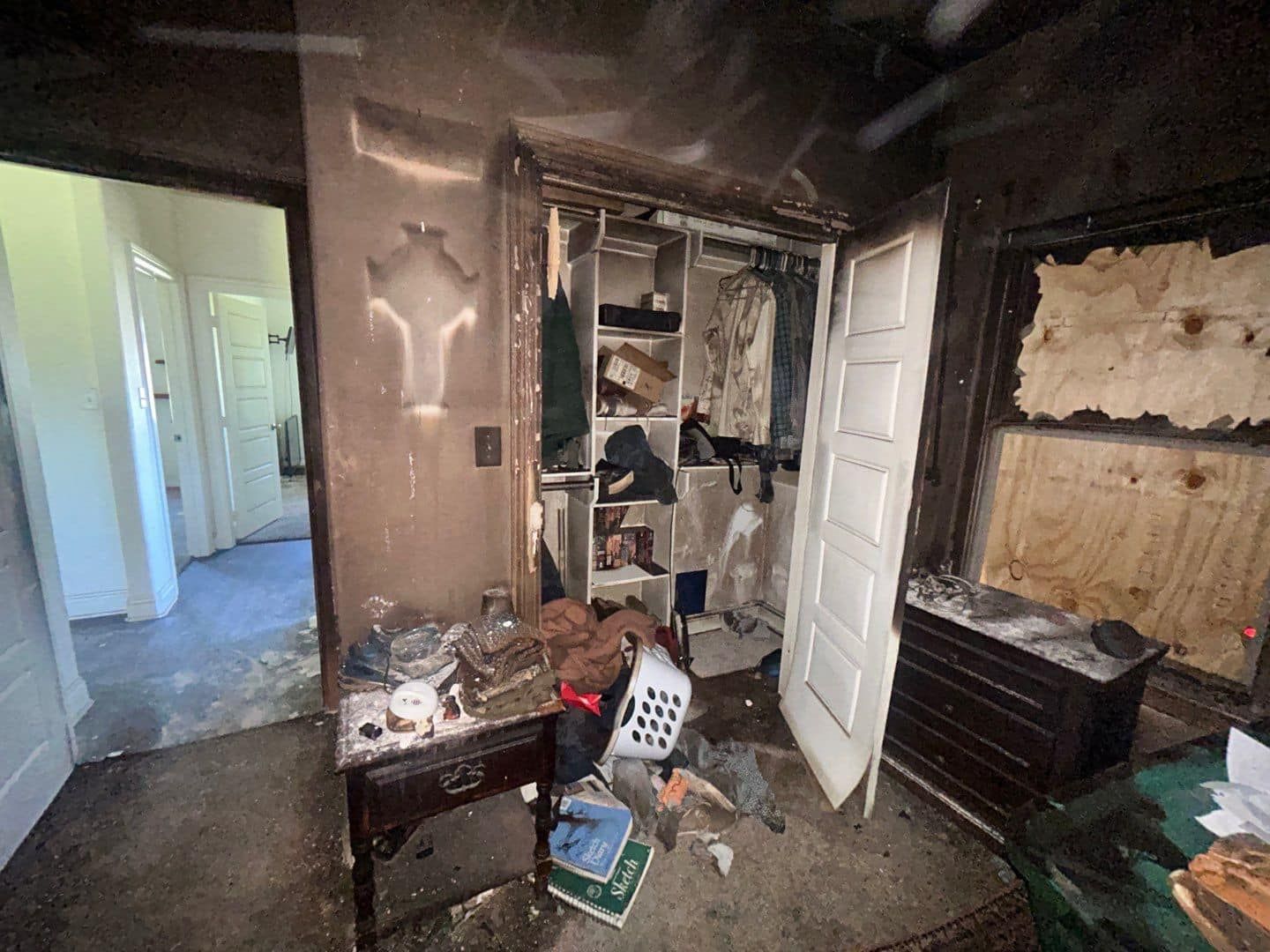 A room with a closet that has been damaged by a fire.