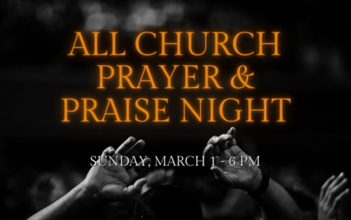 Hand holding glowing string lights against a colorful sunset.