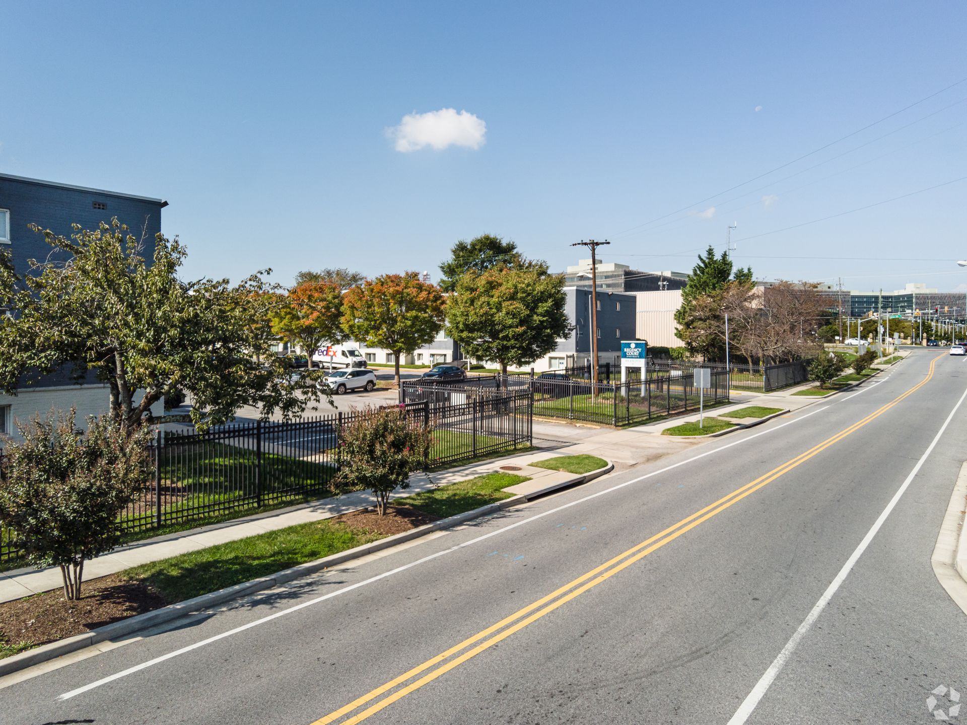 An aerial view of a street with a building in the background