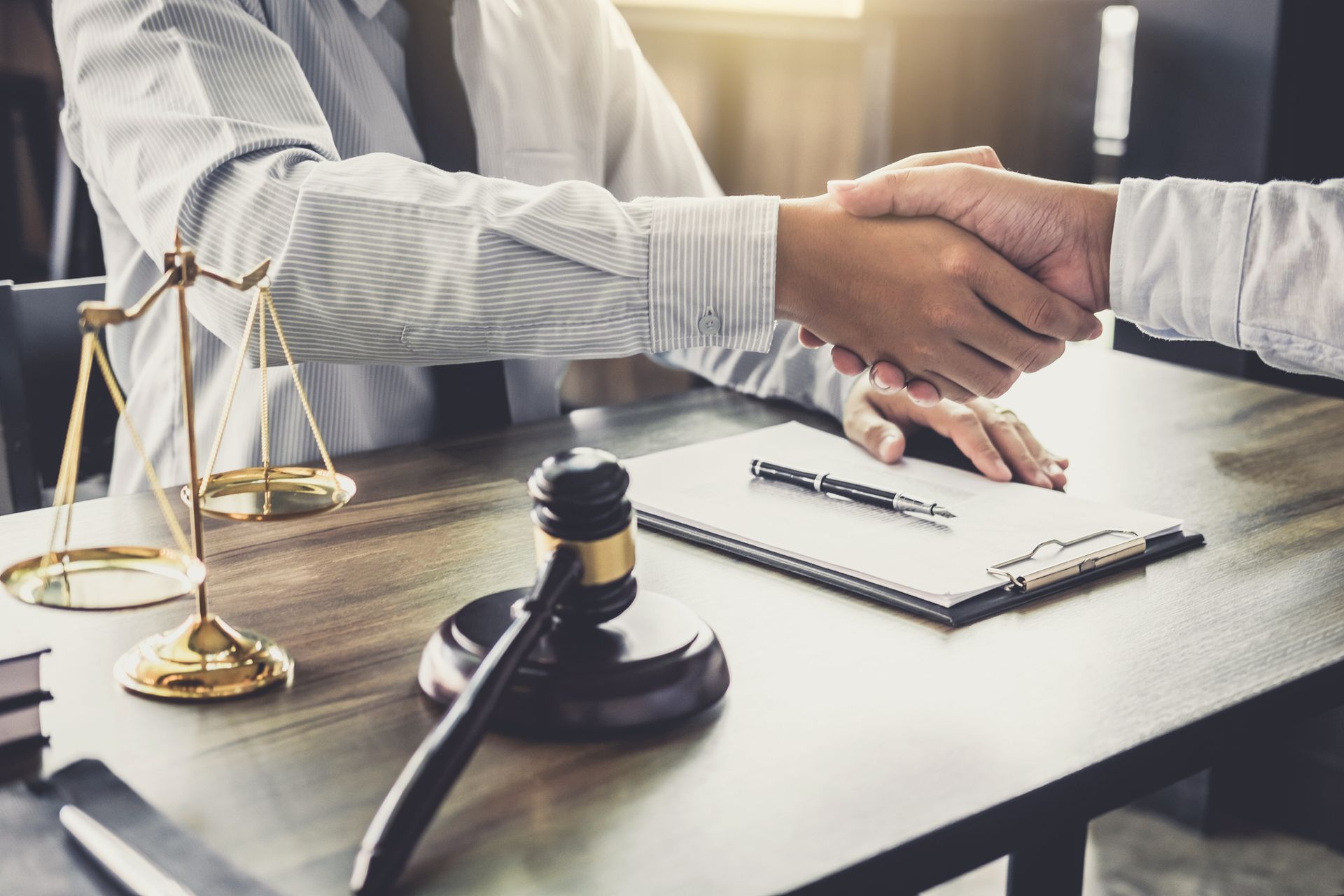 Maritime accident lawyers finalizing agreements with businessman after detailed contract talks.