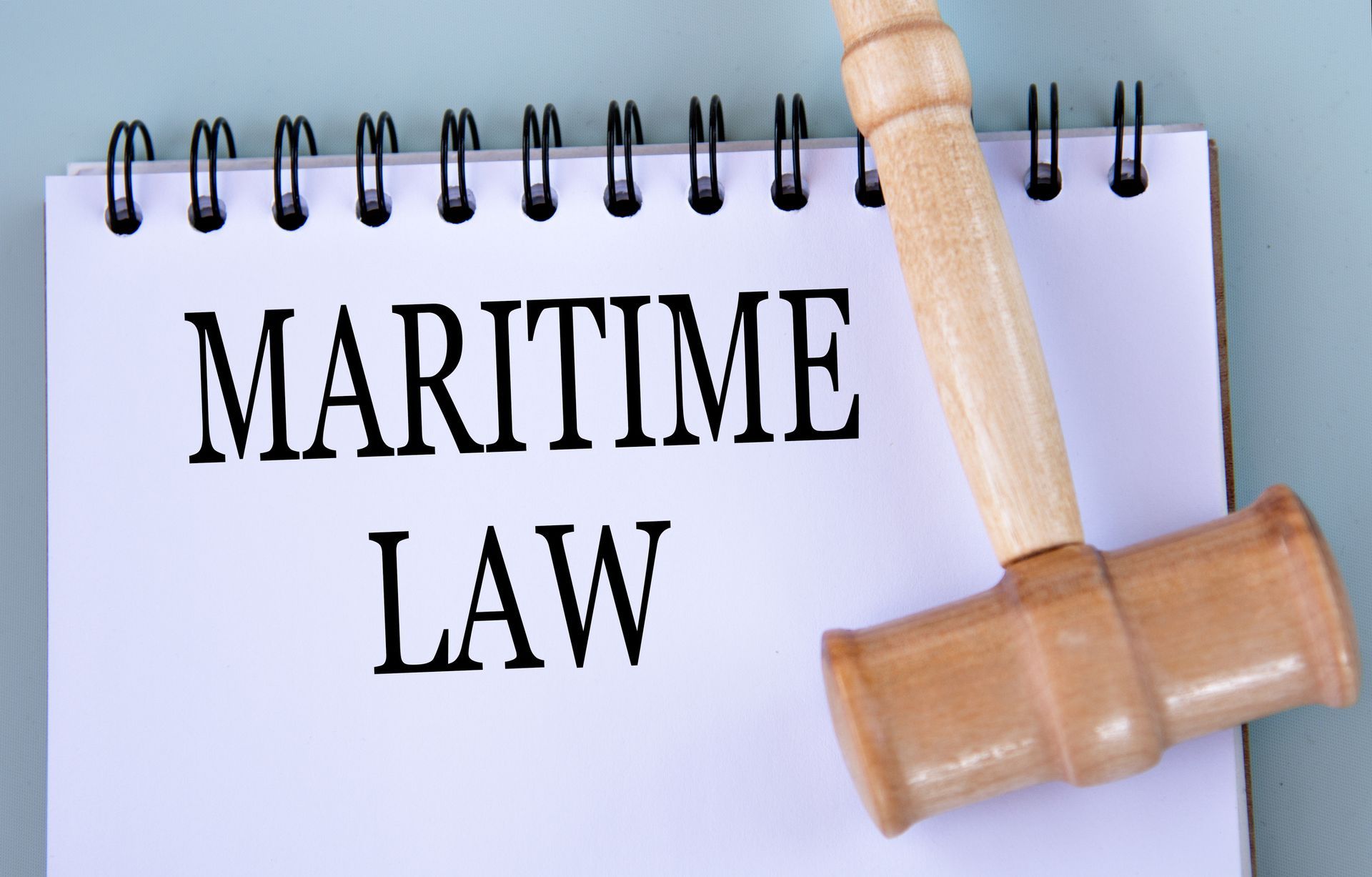 MARITIME LAW words in a notebook with a judge's gavel, symbolizing maritime personal injury lawyers. MARITIME LAW words in a notebook with a judge's gavel, symbolizing maritime personal injury lawyers.