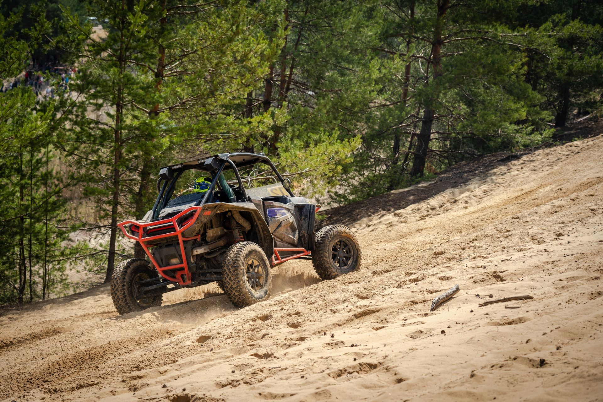 A person is riding a atv down a dirt hill.